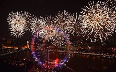 The Houses of Parliament and the London Eye are lit up by a spectacular fireworks display over ...