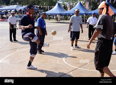 Playing traditional Malay game of Sepak Raga Stock Photo - Alamy