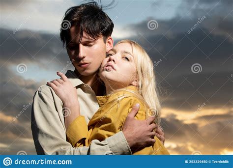 Young Couple in Love Hug Each Other on Sunset. Love Story. Stock Photo ...