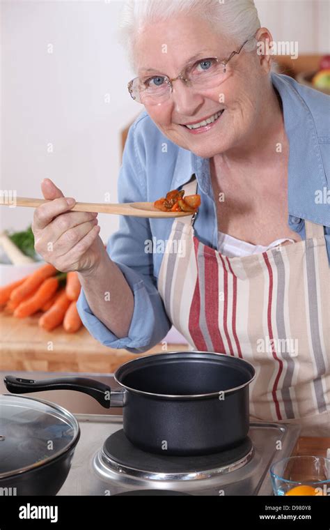 An old lady cooking Stock Photo - Alamy