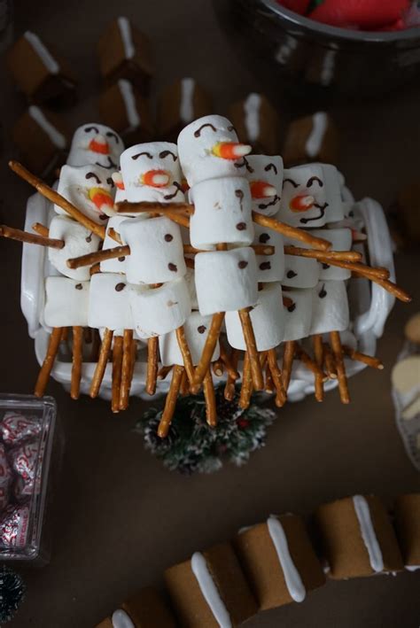 Homemade marshmallow snowmen with pretzel sticks | Marshmallow snowman, Homemade marshmallows ...