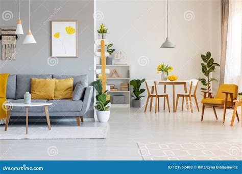 Poster Above Grey Sofa with Yellow Cushions in Open Space Interi Stock ...