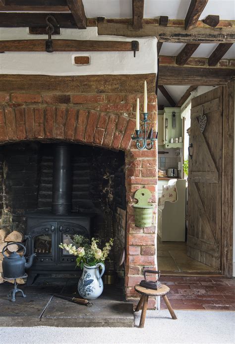 an old brick fireplace in the middle of a living room