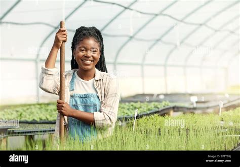 Portrait of a happy woman working on a farm. Smiling farmer working in ...