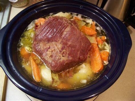 Corned beef brisket is slow cooked with potatoes, turnips, carrots and ...