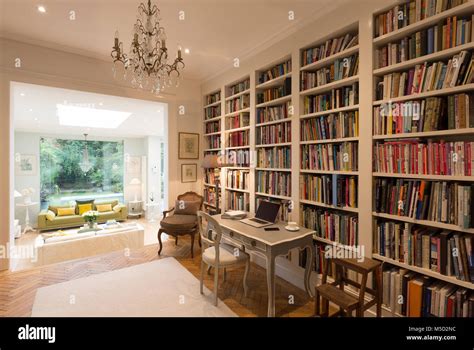 Books on bookshelves in luxury home showcase interior library Stock Photo - Alamy