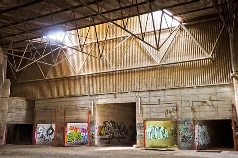 An abandoned factory building with colorful graffiti on the walls free ...