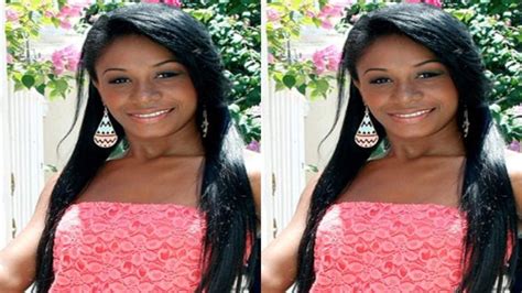 a woman with long black hair wearing a pink dress and earrings smiling ...