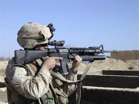 US Marine Sites Through the Scope Atop His 556mm M16A2 Rifle ...