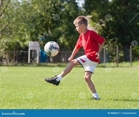 Boy Kicking Football Stock Image - Image: 28684211