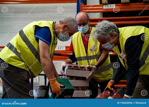 Volunteers at a food bank editorial photo. Image of person - 196665056