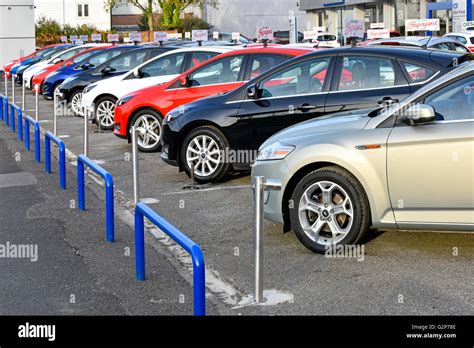 Row of used car dealers second hand Ford cars for sale on garage ...