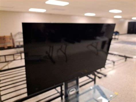 Hisense 58" Roku TV w/ glass mounting TV stand - Auction Solutions Inc