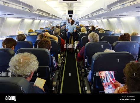 Passengers on a aeroplane, interior of seating area on aircraft Stock Photo: 57193834 - Alamy