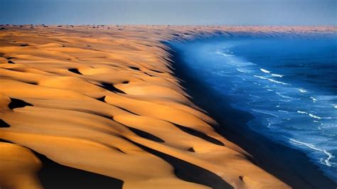 Dunes of the Namib Desert meet the Atlantic Ocean, Namibia, Africa ...