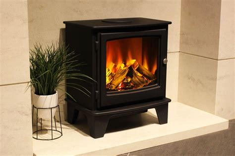 a black stove sitting next to a potted plant on top of a white counter