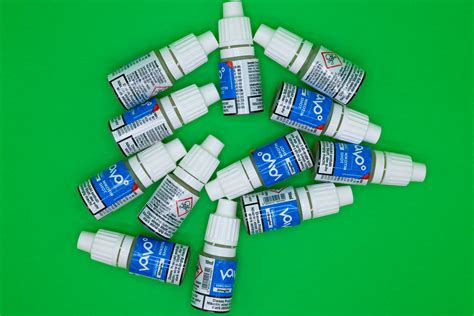 Bottles of Nicotine Shots Lying against a Green Background · Free Stock ...