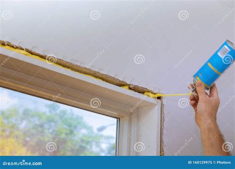 Man in a Using a Mounting Foam Window Installation Stock Image - Image ...