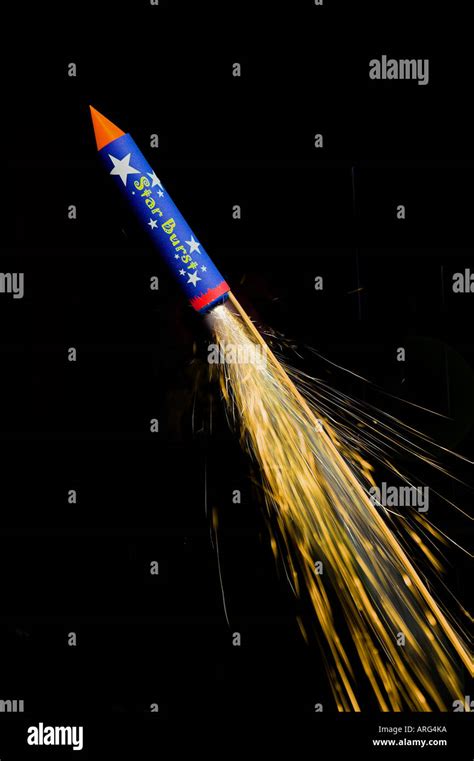 A firework rocket with trail of sparks captured against black Stock Photo, Royalty Free Image ...