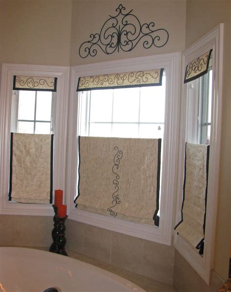 Top down-bottom up Roman shades provide privacy for this master bath while letting in natural ...