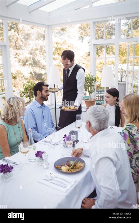 Waiter serving food hi-res stock photography and images - Alamy