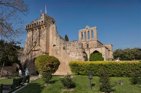 General view of 'Bellapais'monastery ruins with tourists walking in the garden near Girne at ...