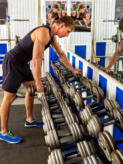 Man in Gym Workout with Fitness Equipment. Cropped Shot. Stock Photo ...