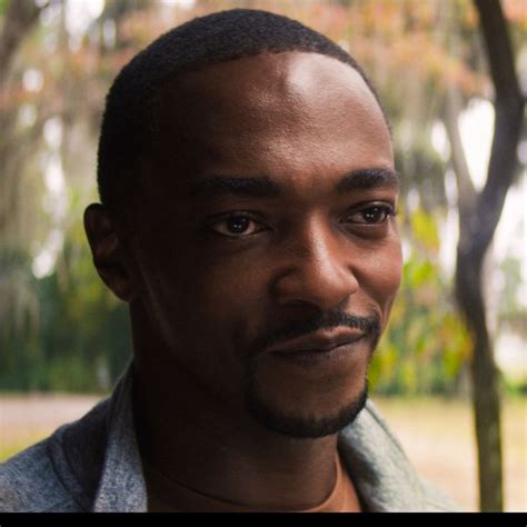 a close up of a person with trees in the background