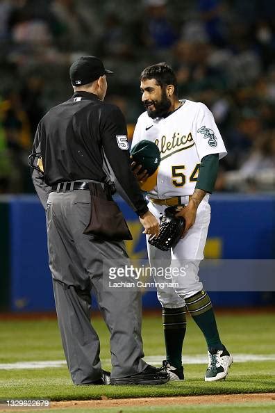 Sergio Romo of the Oakland Athletics has his hat and glove inspected... News Photo - Getty Images