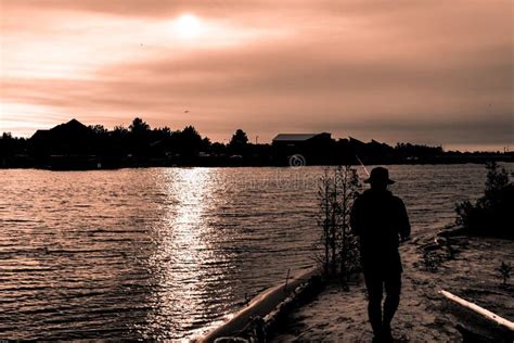 Silhouette of Guy in Hat Fishing in River on Sunset Editorial Photography - Image of hobby ...