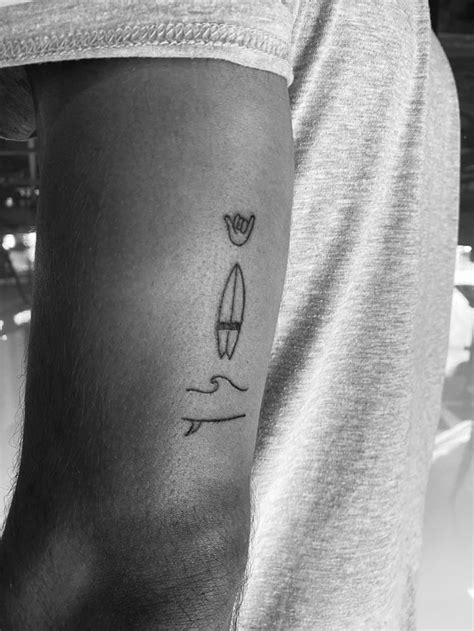 a man with a small tattoo on his arm