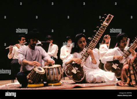 Indian group playing sitar, tabla - wearing white Stock Photo - Alamy