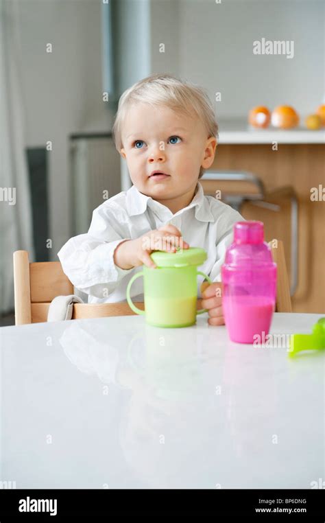 Boy sitting at a dining table Stock Photo - Alamy