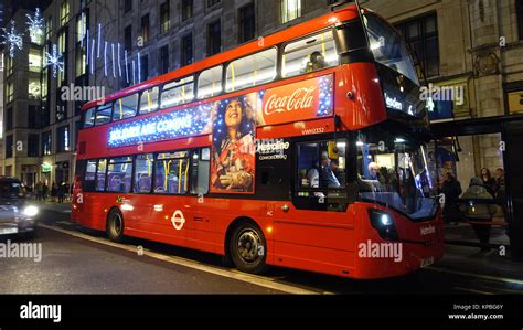 Red bus by night, London UK Stock Photo - Alamy