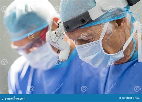 Senior surgeon operating stock photo. Image of concentration - 90791884