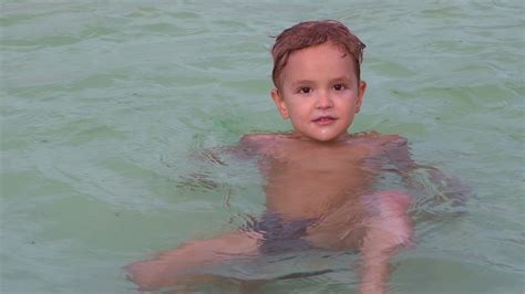 Portrait little boy swimming in the pool. Happy kid 4 years old enjoy ...