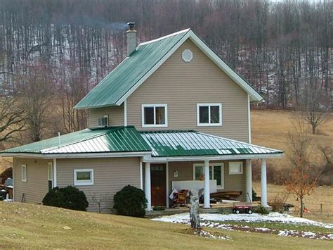 Green Metal Roof, Tan/Mocha paint with White trim....red door or wood? | Green roof house, House ...