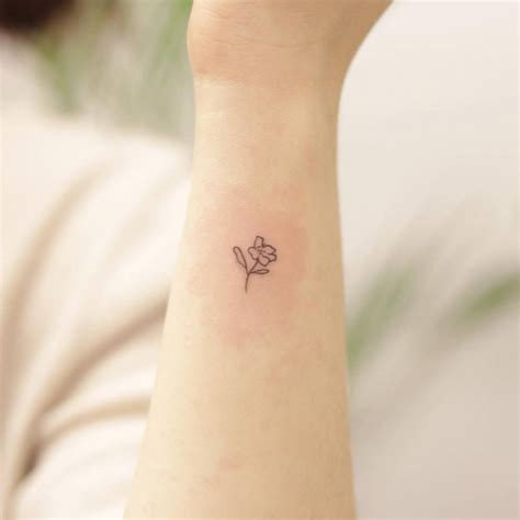 Minimalist flower tattoo on the wrist