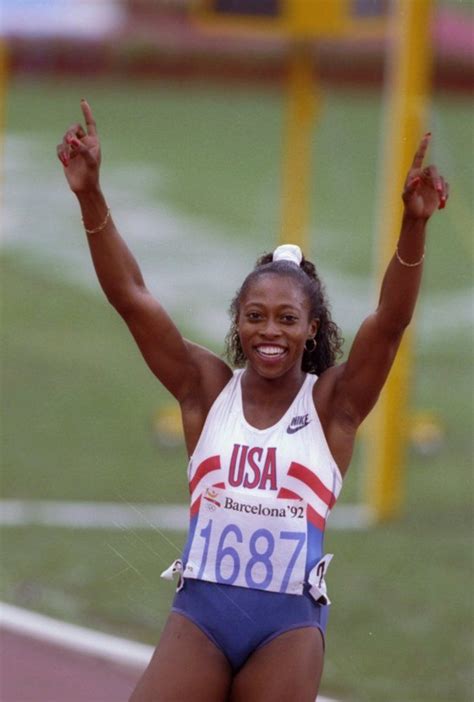 a female athlete celebrating her victory on the track