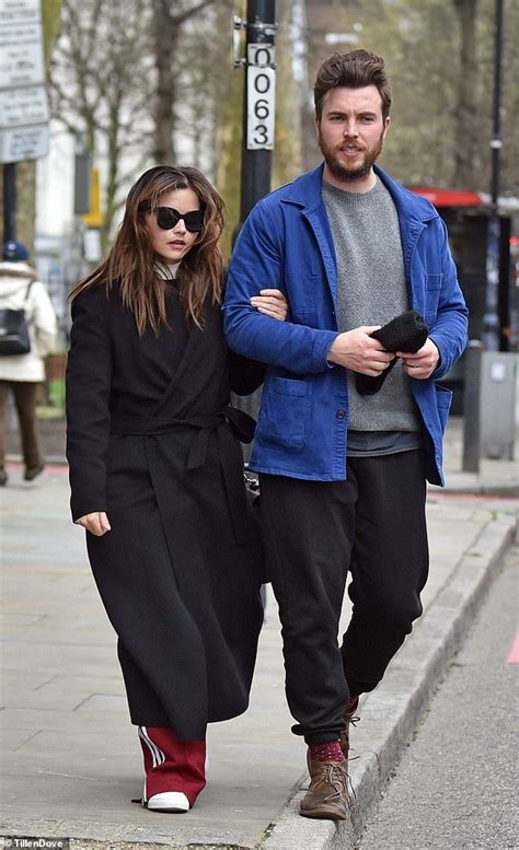 a man and woman walking down the street