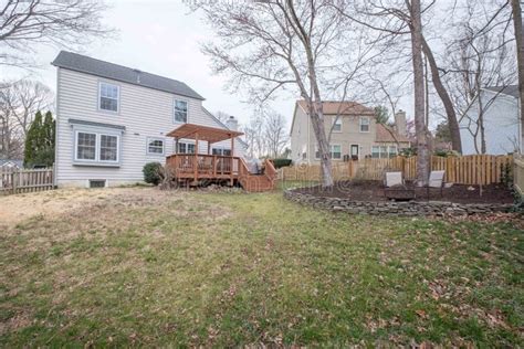 Beautiful Backyard Lawn of a Two-storey White House with a White Sky in ...