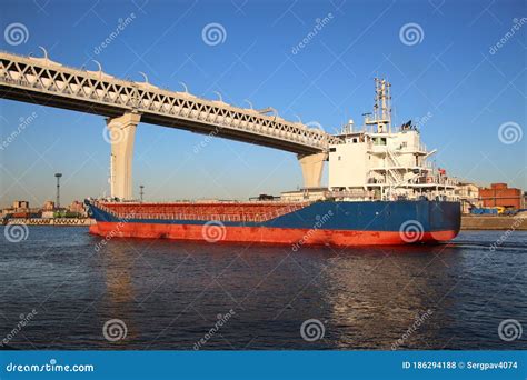 Cargo Ship Sailing Under a Bridge Stock Photo - Image of coast ...