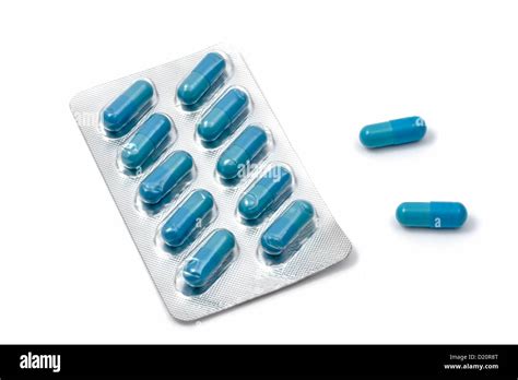 Blue capsules isolated on white background Stock Photo - Alamy