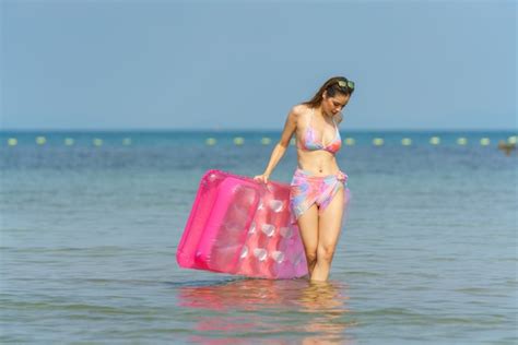 Premium Photo | Portrait of woman posing outdoors at the sea beach