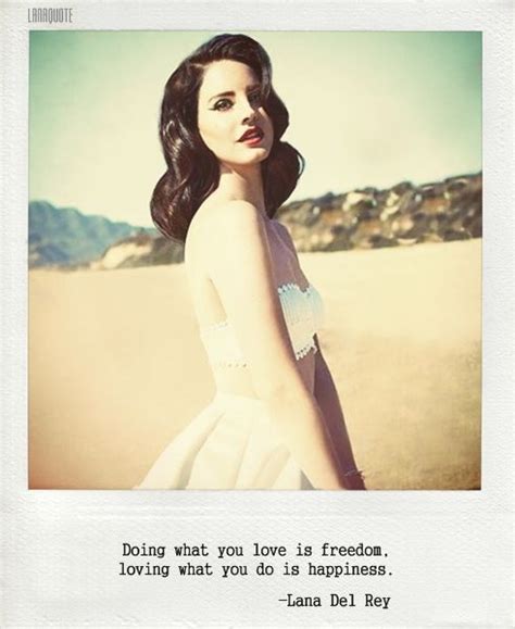 a woman in a white dress standing on the beach with her arms behind her ...