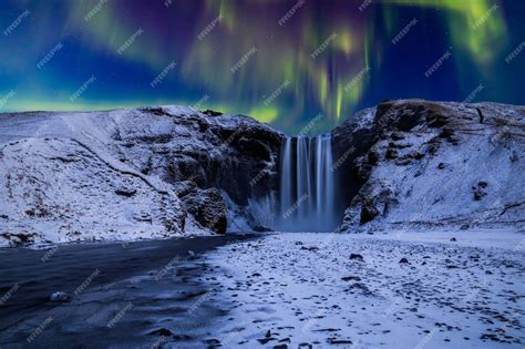 Premium Photo | Skogafoss waterfall in the winter at night under the ...