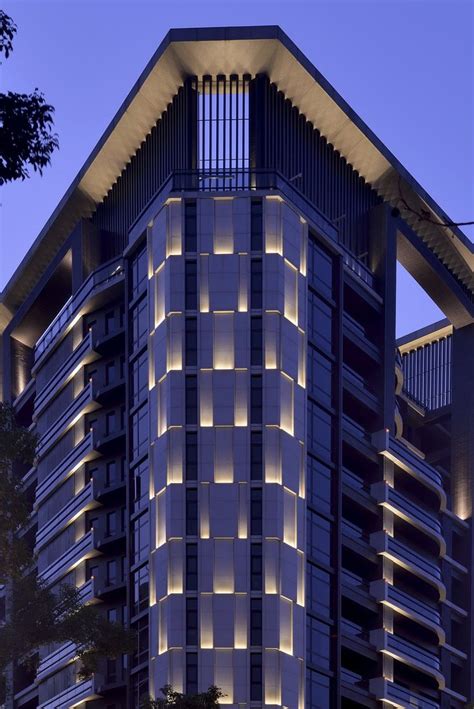 a tall building with lots of windows lit up at night