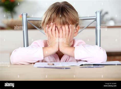 Frustrated child unable to complete her homework Stock Photo - Alamy