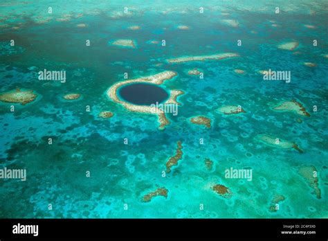 Aerial view of The Great Blue Hole, a UNESCO world natural heritage site, Lighthouse Reef Atoll ...