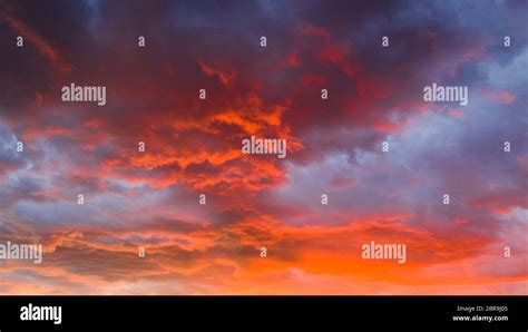 Fire Orange Sunset With Blue Cloud Background Stock Photo - Alamy